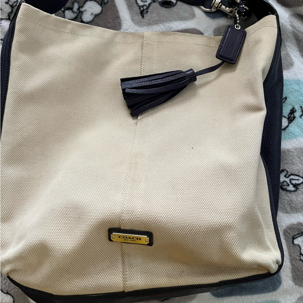 Coach purse, cream canvas with dark purple leather sides and strap.